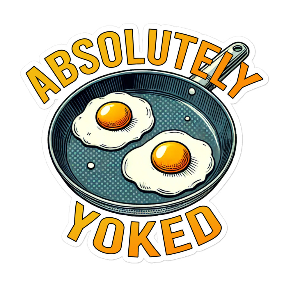 Illustration of two sunny-side-up eggs in a frying pan with the phrase Absolutely Yoked in bold letters at the top and bottom.