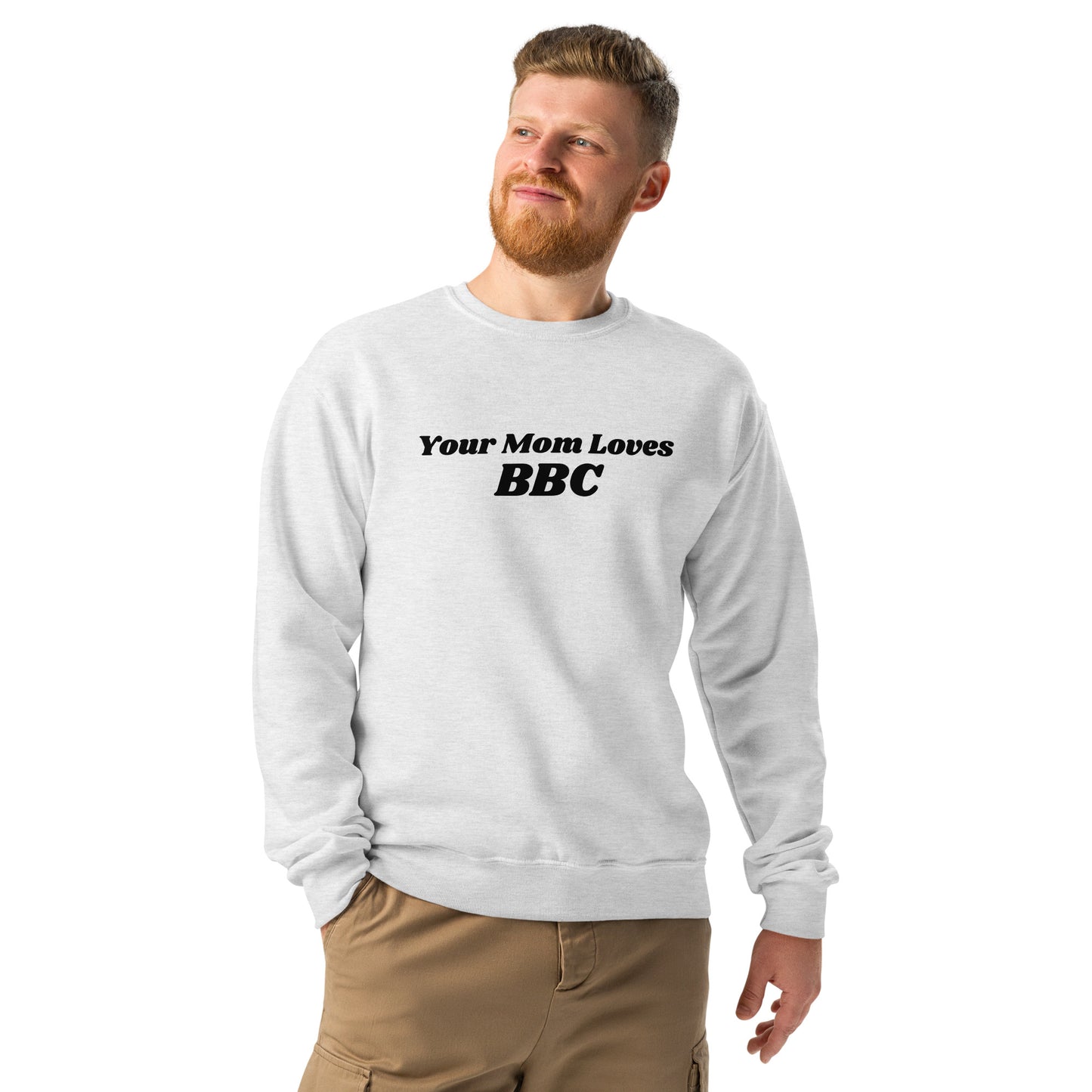 A bearded man with short hair sports the Bougie Boiz Clubs Your Mom Loves BBC light gray sweatshirt. He pairs it with khaki pants and poses against a plain white background.