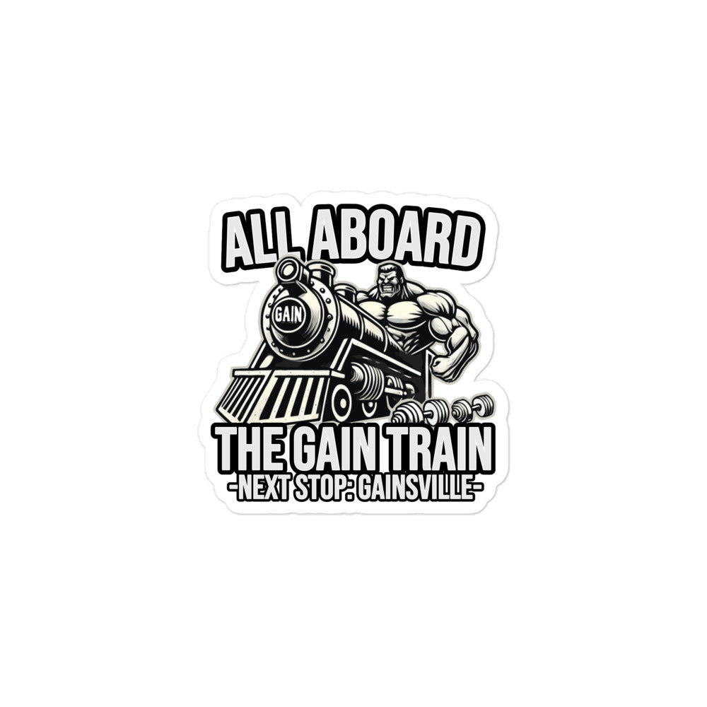 A sticker by Bougie Boiz Club featuring a muscular figure in gym gear driving a locomotive labeled GAIN, with the text ALL ABOARD THE GAIN TRAIN - NEXT STOP: GAINSVILLE-. Ideal for celebrating strength and fitness for those living the swole life.