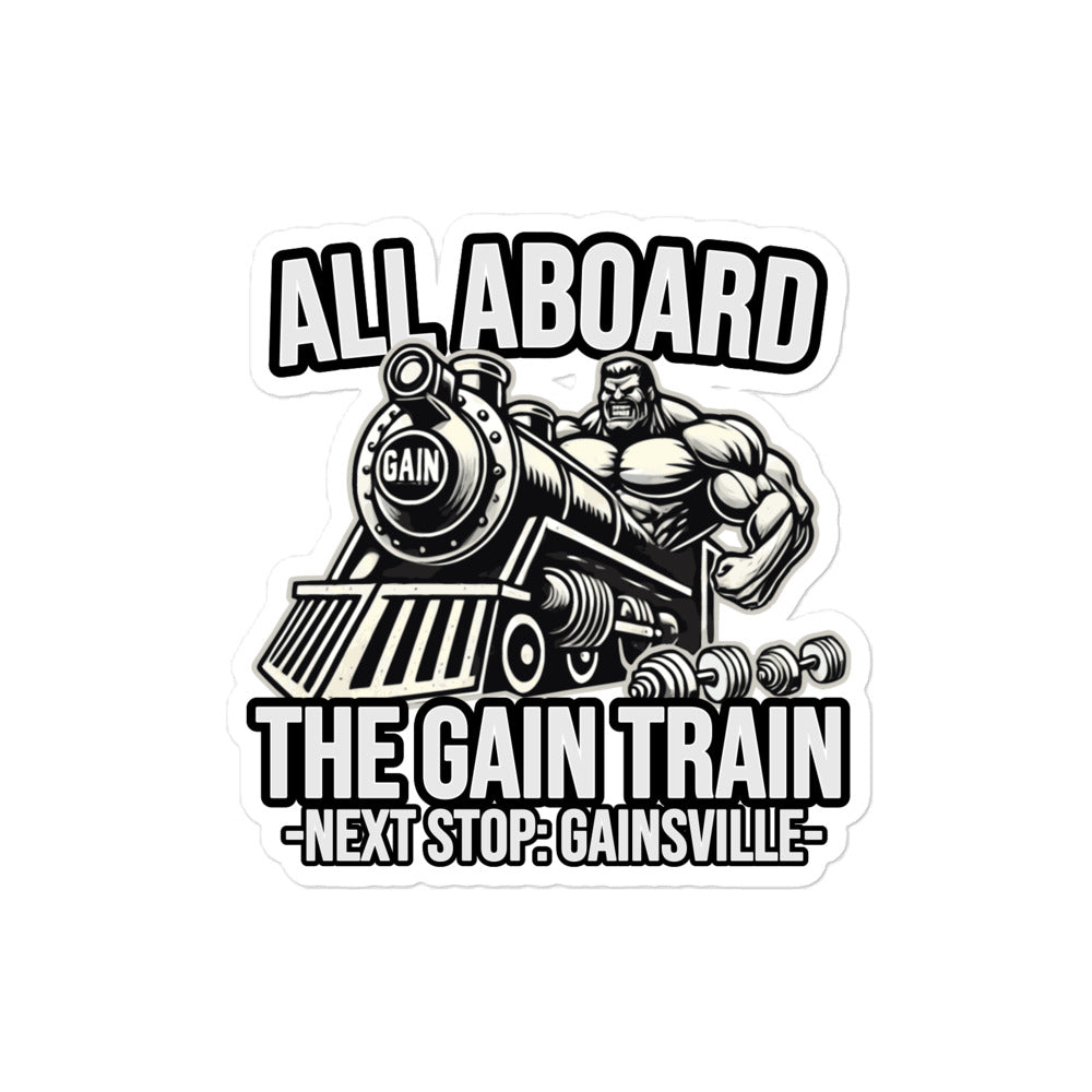 A sticker by Bougie Boiz Club featuring a muscular figure in gym gear driving a locomotive labeled GAIN, with the text ALL ABOARD THE GAIN TRAIN - NEXT STOP: GAINSVILLE-. Ideal for celebrating strength and fitness for those living the swole life.