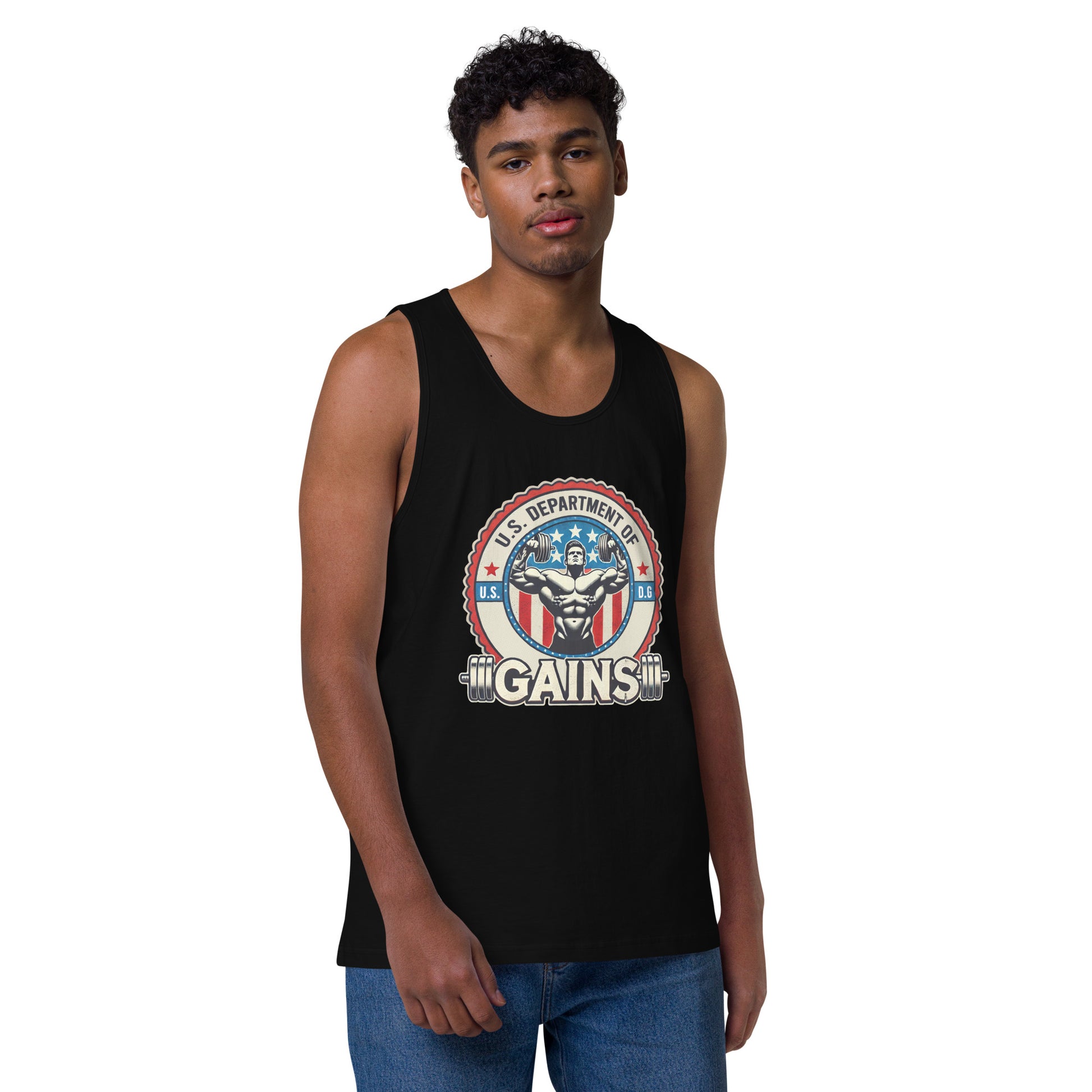 A person confidently poses in a U.S. Department of Gains tank top by Bougie Boiz Club, featuring weights and an emblem. With short curly hair and blue jeans, they stand against a plain white background. The attire showcases their gym hero style.