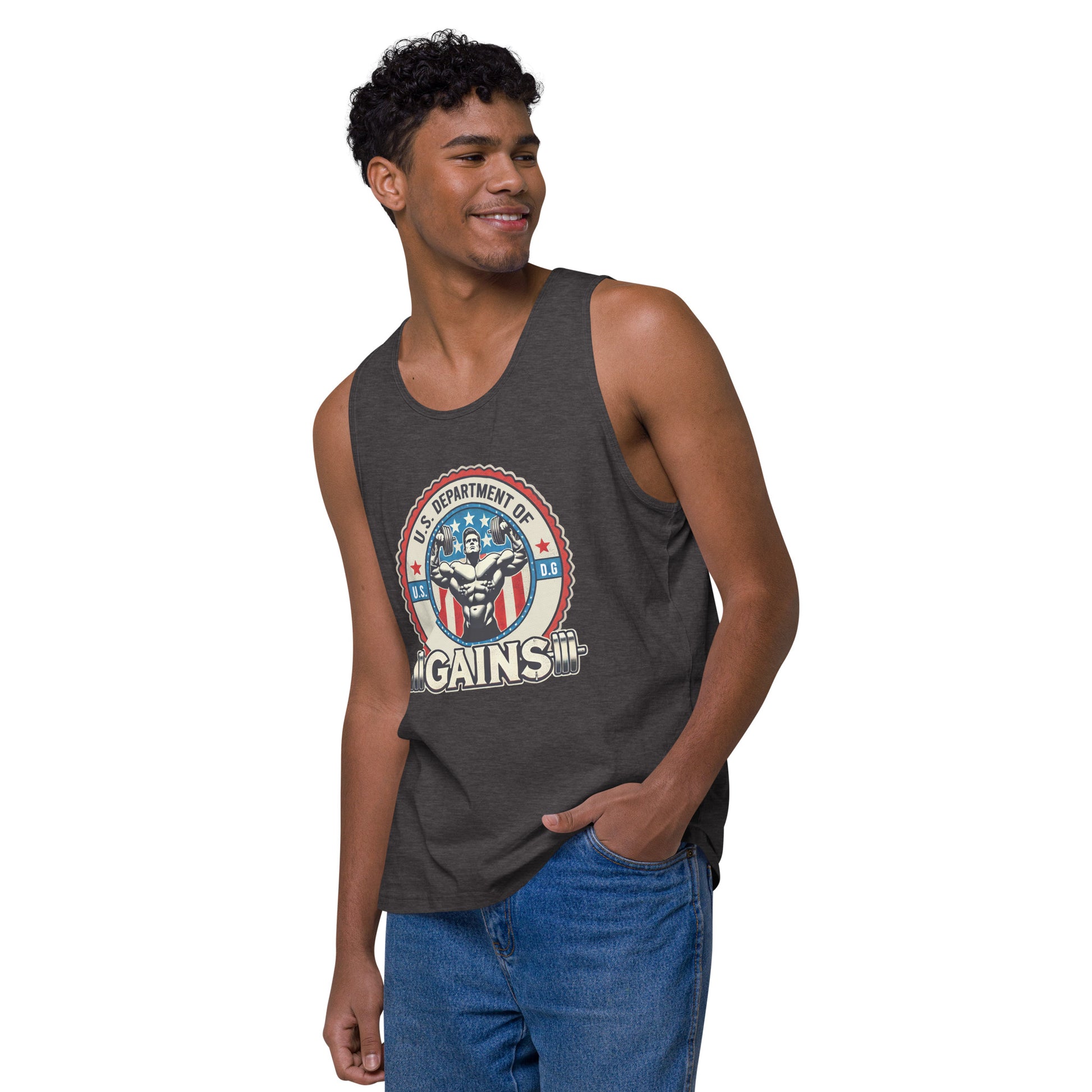 A person confidently poses in a U.S. Department of Gains tank top by Bougie Boiz Club, featuring weights and an emblem. With short curly hair and blue jeans, they stand against a plain white background. The attire showcases their gym hero style.