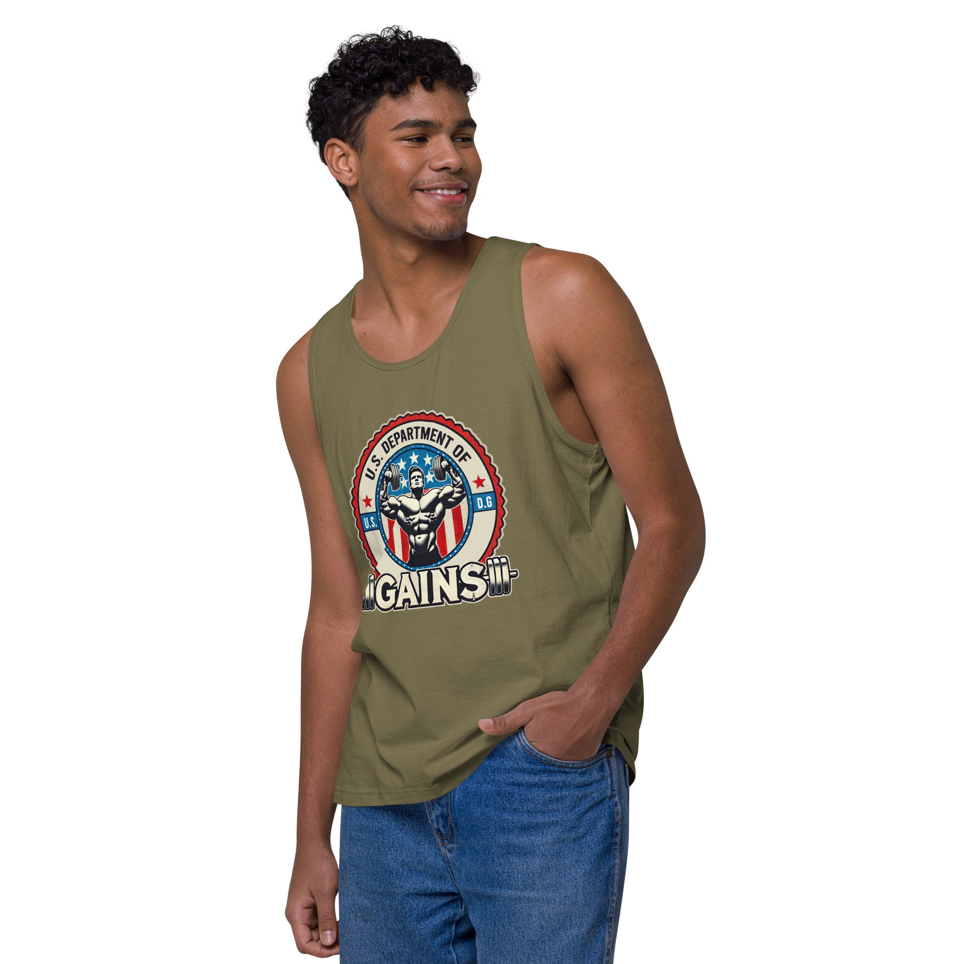 A person confidently poses in a U.S. Department of Gains tank top by Bougie Boiz Club, featuring weights and an emblem. With short curly hair and blue jeans, they stand against a plain white background. The attire showcases their gym hero style.