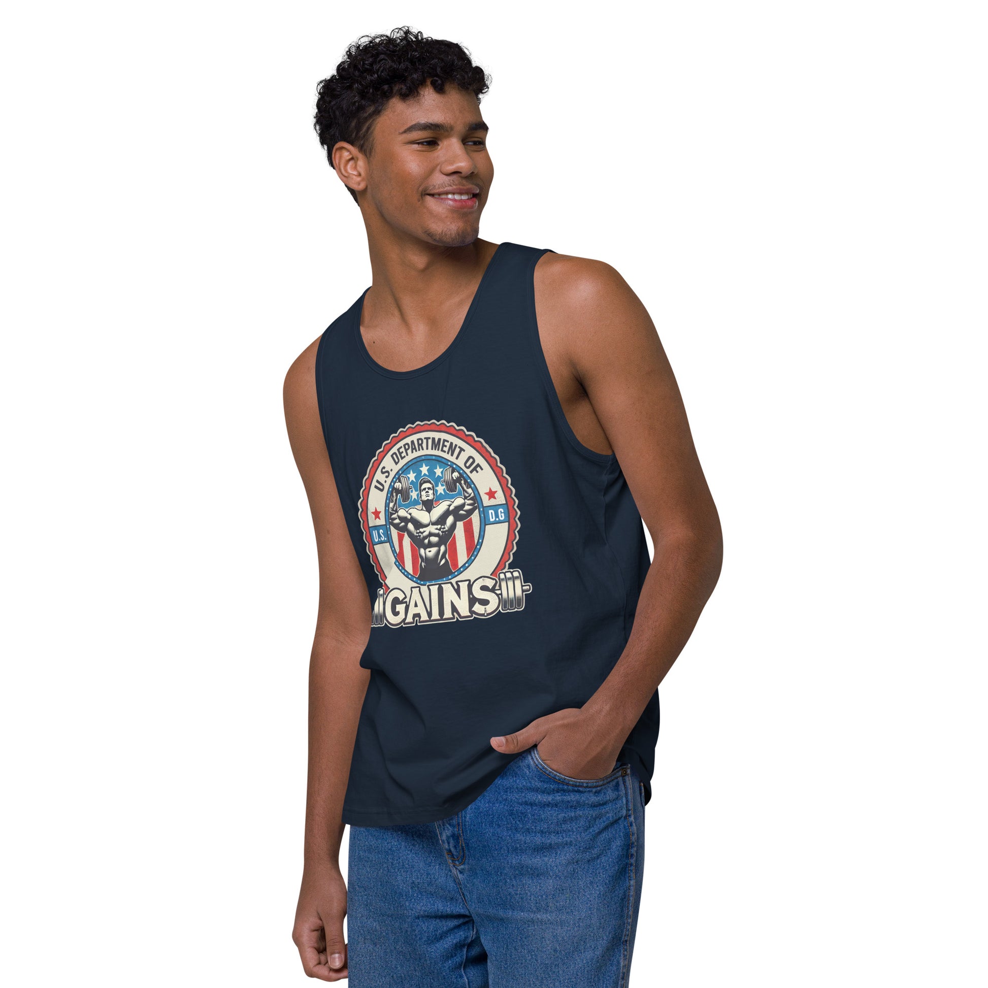 A person confidently poses in a U.S. Department of Gains tank top by Bougie Boiz Club, featuring weights and an emblem. With short curly hair and blue jeans, they stand against a plain white background. The attire showcases their gym hero style.