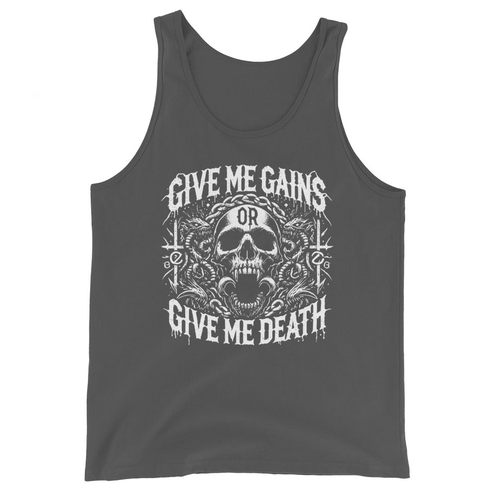 A bearded man embraces the iron life in a Bougie Boiz Club Give Me Gains - Tank Top featuring a skull graphic. Against a plain white backdrop, he pairs this black top with blue shorts, exuding serious gym vibes.