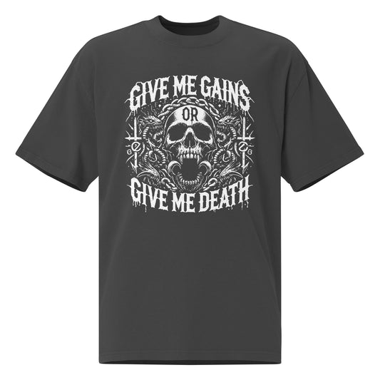 The Bougie Boiz Clubs Give Me Gains oversized faded T-shirt is dark gray with a skull graphic surrounded by intricate designs, featuring the bold white text Give Me Gains or Give Me Death, making it perfect for your next gym session.