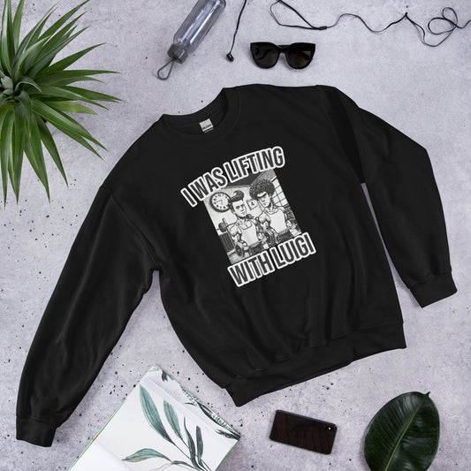 The Bougie Boiz Clubs Lifting With Luigi unisex sweatshirt in black features cartoon characters and the playful text I was Lifting With Luigi, set against sunglasses, a watch, a plant, an open book, and a water bottle on gray—merging comfort and humor for casual outings.