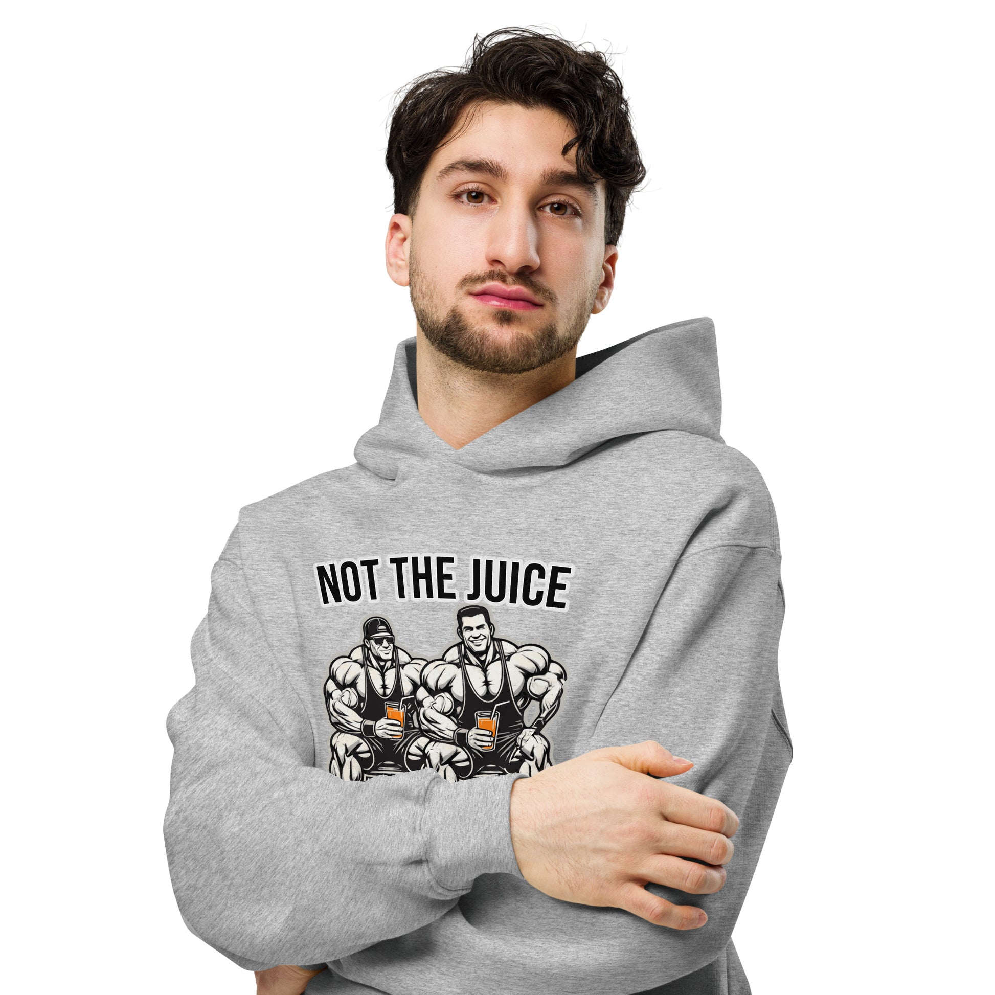 A man wearing Bougie Boiz Clubs Not The Juice - Unisex Oversized Hoodie, featuring two knights with goblets and gym humor text, complements khaki cargo pants. This relaxed fit stands out against a plain white background.