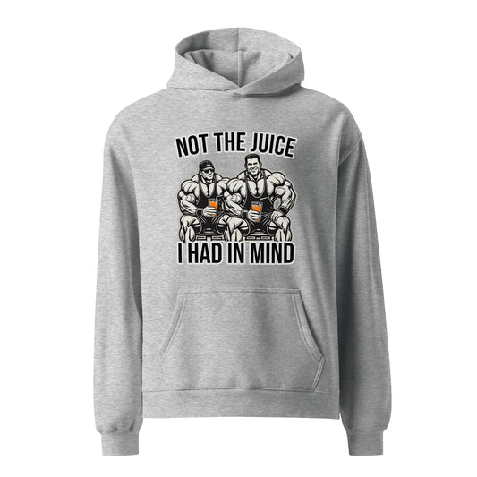 A man wearing Bougie Boiz Clubs Not The Juice - Unisex Oversized Hoodie, featuring two knights with goblets and gym humor text, complements khaki cargo pants. This relaxed fit stands out against a plain white background.