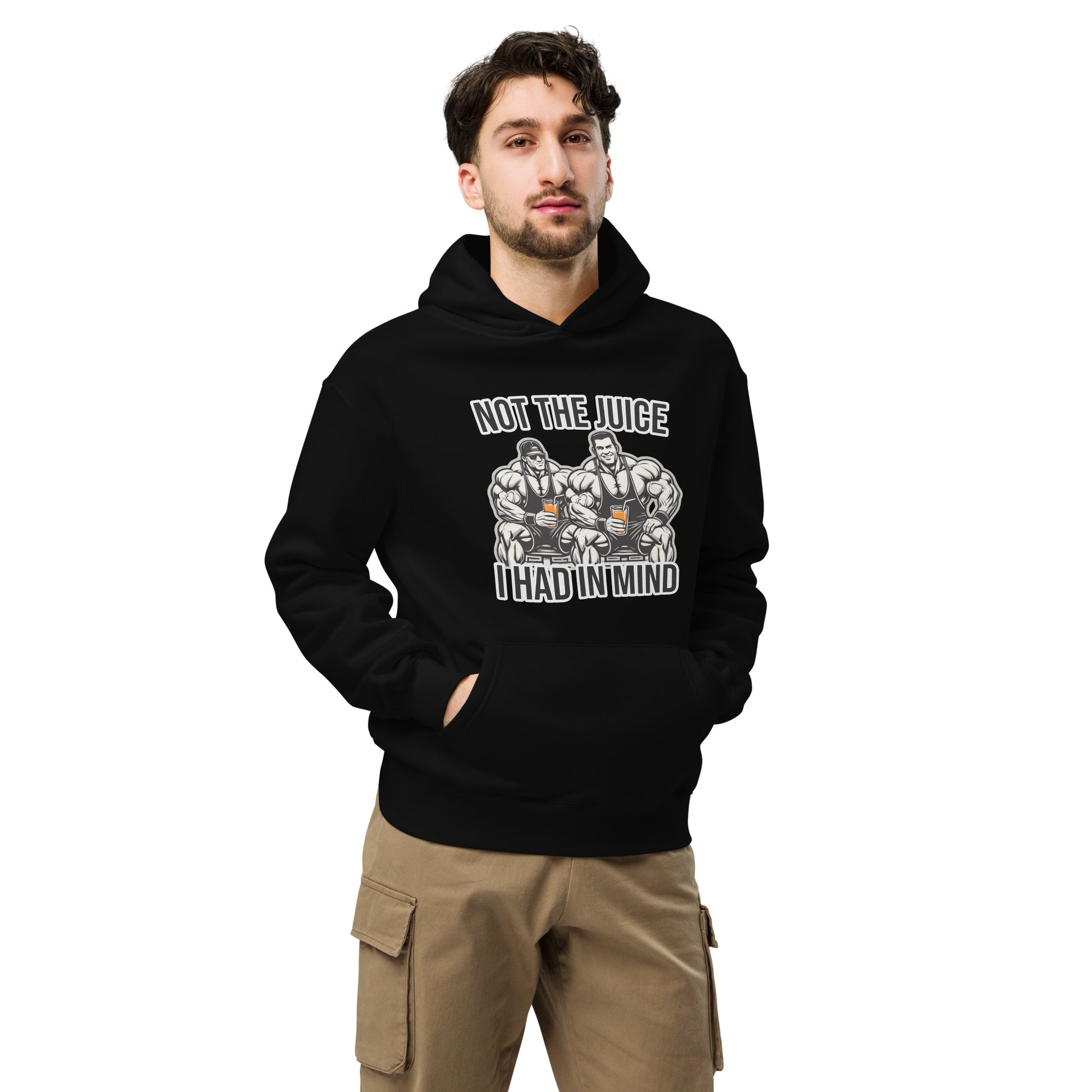 A man wearing Bougie Boiz Clubs Not The Juice - Unisex Oversized Hoodie, featuring two knights with goblets and gym humor text, complements khaki cargo pants. This relaxed fit stands out against a plain white background.