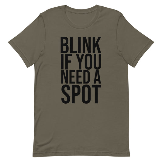 In the gym, a person wears the Bougie Boiz Club Blink If You Need A Spot Unisex T-shirt, highlighted amid weightlifting benches and exercise gear, perfectly setting off this quirky tee.