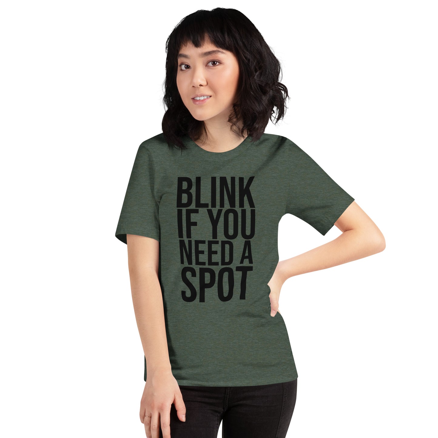 In the gym, a person wears the Bougie Boiz Club Blink If You Need A Spot Unisex T-shirt, highlighted amid weightlifting benches and exercise gear, perfectly setting off this quirky tee.