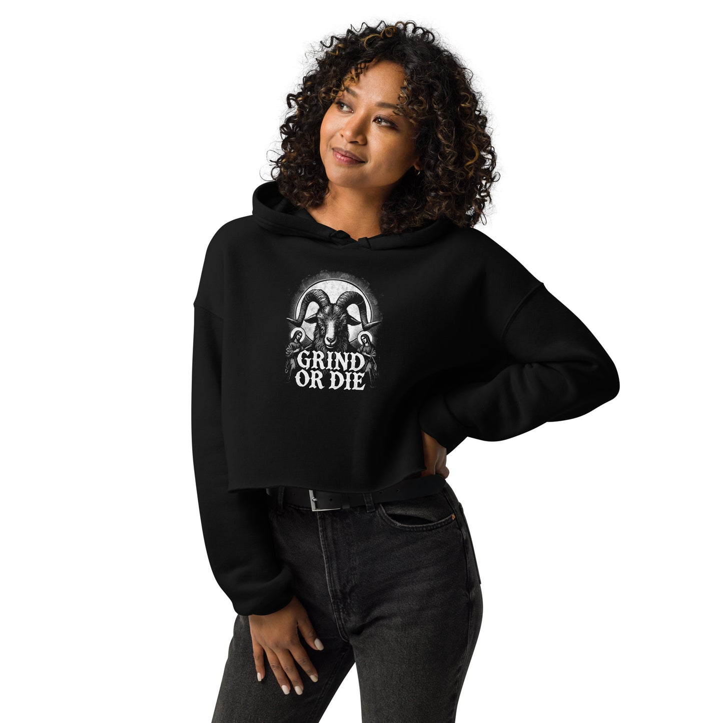 A woman in a Bougie Boiz Club Grind Or Die Womens Crop Hoodie stands confidently, her curly hair framing her face. With one hand on her hip, she gazes upward with a slight smile.